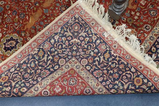 An Indian red and blue ground carpet 319 x 153cm